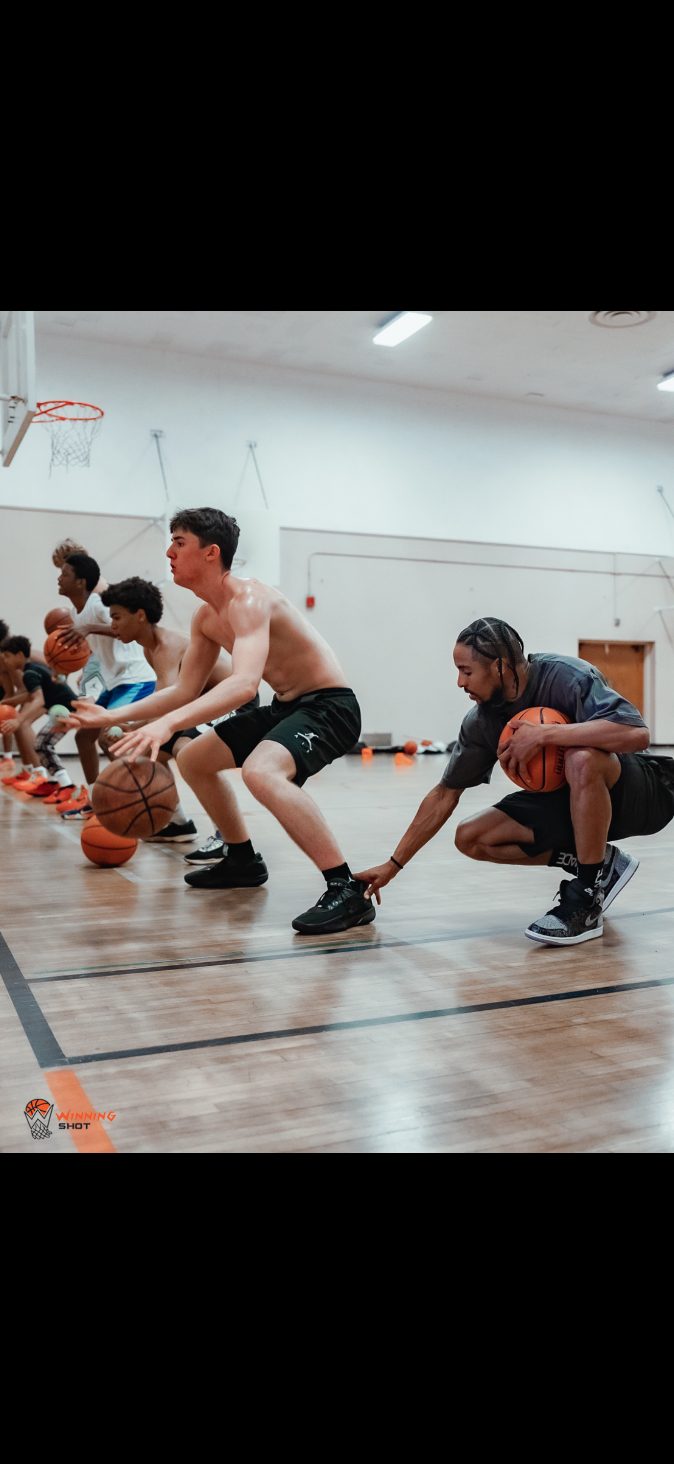 Live basketball instruction and player development inside the training gym.