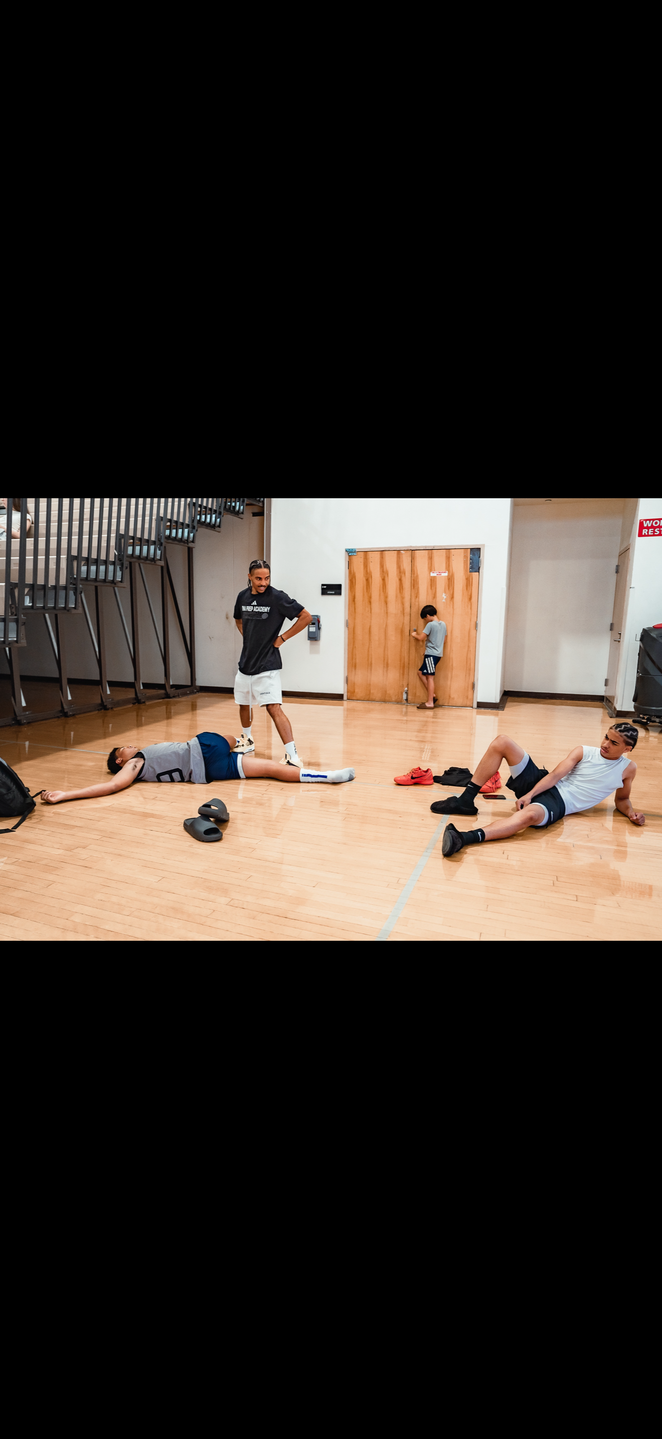 Youth basketball skill development captured during a WE TRAIN TO WINN session.
