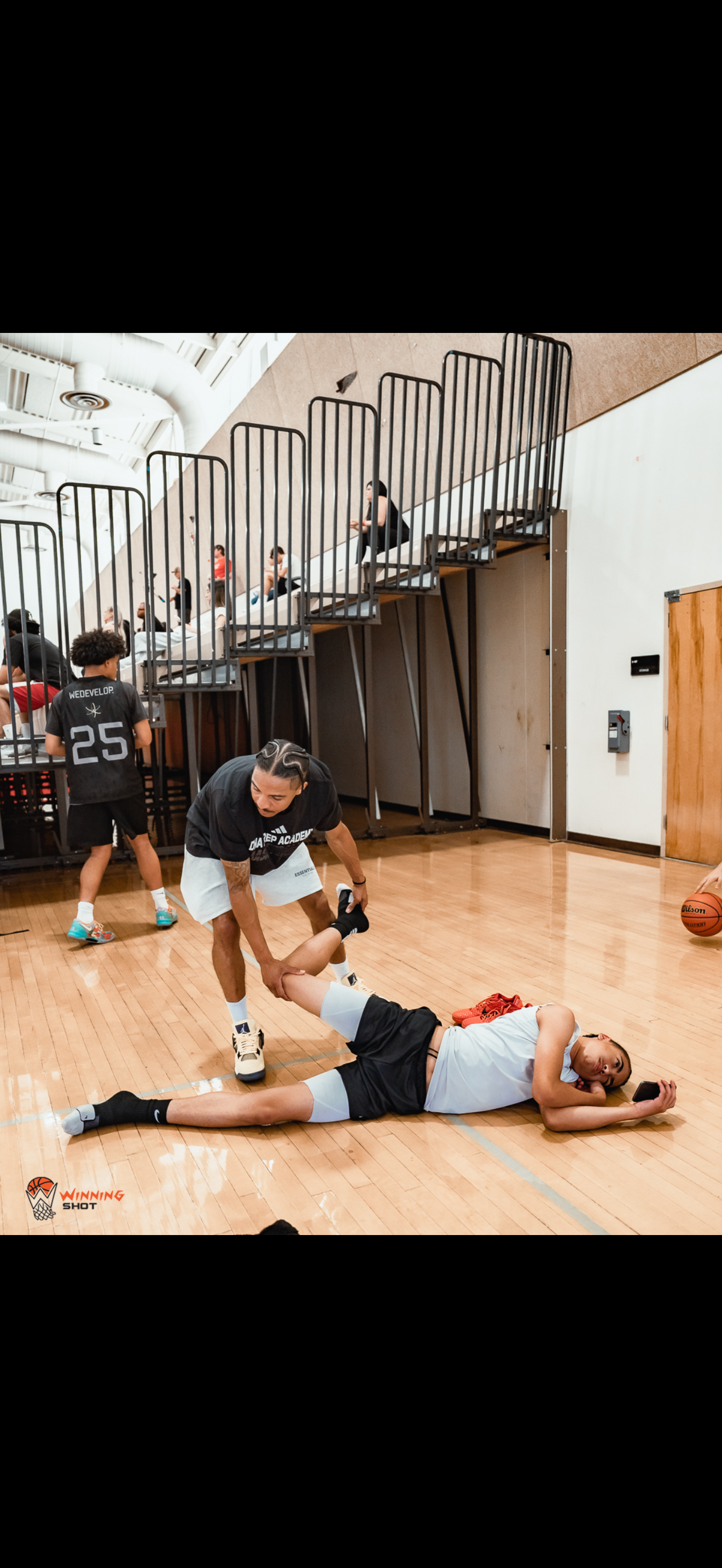 Youth basketball coaching and live skill work during an in-gym session.